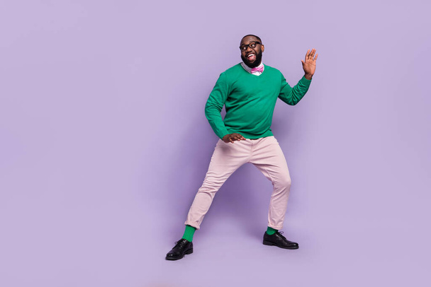 Full body image of overjoyed good mood man enjoy discotheque in nightclub isolated on purple color background. - Fotó, kép