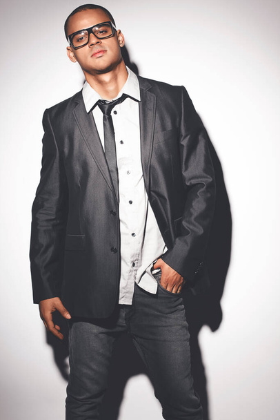 Man fashion model posing against a studio background. - Foto, Imagen