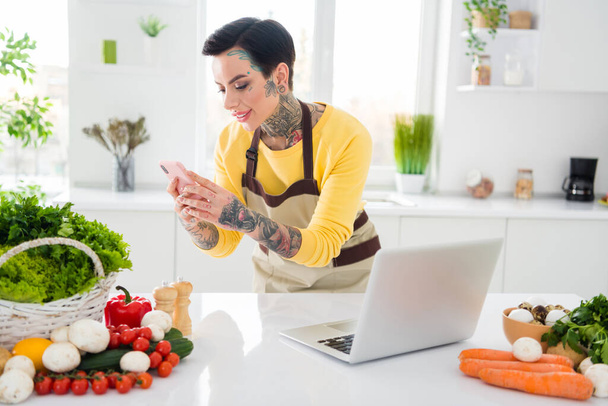Photo of pretty girl with brown hair tattoo and piercing take picture of all ingredients products she use to prepare breakfast. - Fotoğraf, Görsel