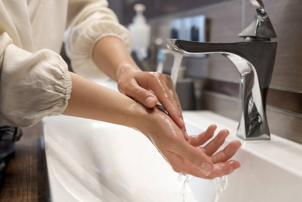 Woman washing hands in bathroom, closeup view - Foto, imagen