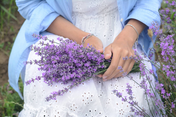 Woman with bouquet of beautiful lavender flowers outdoors, closeup - Fotoğraf, Görsel