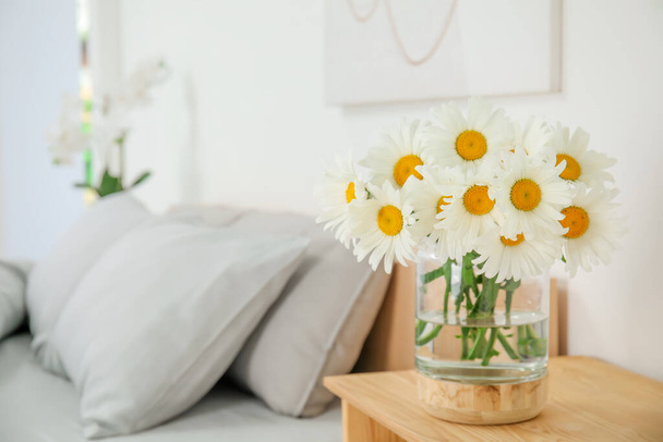 Bouquet of beautiful daisy flowers on wooden table in bedroom, space for text - Photo, Image