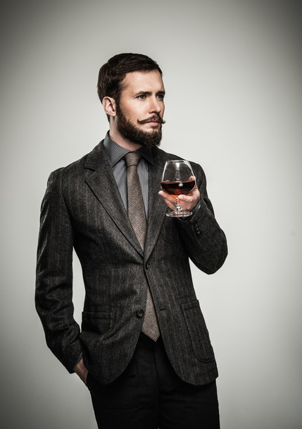 jóképű, jól öltözött férfi kabát pohár ital - Fotó, kép