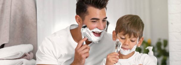 Father and son having fun while shaving in bathroom. Banner design - Foto, Bild