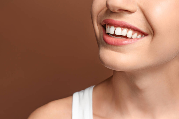 Woman with diastema between upper front teeth on brown background, closeup - Fotografie, Obrázek