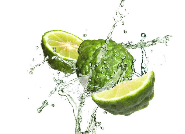 Fresh ripe bergamot fruits and splashing water on white background - Zdjęcie, obraz