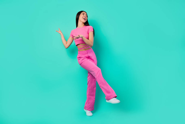 Full body photo of energetic active cheerful lady dancing relaxing in nightclub isolated on teal color background. - Photo, Image