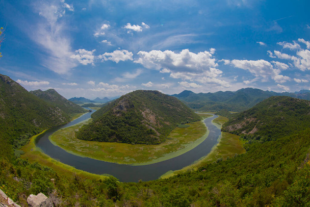 View of the western tip of Lake Skadar, Montenegro. Crnojevic river bend around green mountain peaks. Great view of the river. - Fotó, kép
