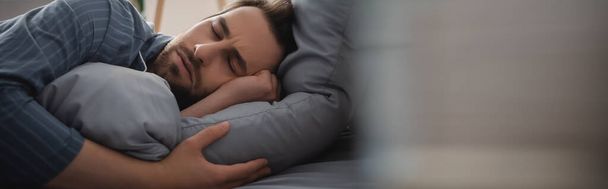 Man in pajama sleeping on bed at home in morning, banner  - Photo, image