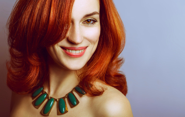 Emotive portrait of a fashionable model with red (ginger) curly hair and natural make-up - Photo, Image