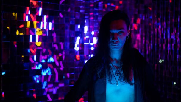 Portrait of a transgender model with a naked torso in a studio with neon lighting - Valokuva, kuva