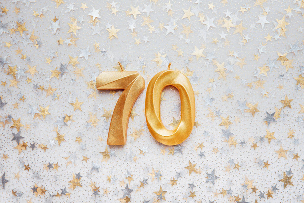 Number 70 seventy golden celebration birthday candle on Festive Background. seventy years birthday. concept of celebrating birthday, anniversary, important date, holiday - Photo, Image