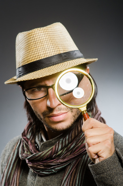Funny detective with smoking pipe and magnifying glass - Photo, Image