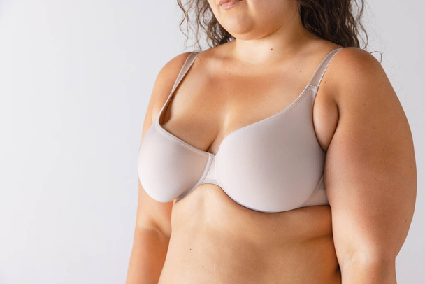 Cropped image of plump, fat female body in underwear isolated over grey studio background. Medical treatment. Concept of beauty, body and skin care, health, plastic surgery, cosmetics, ad - Foto, immagini