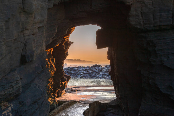Beach rocky coastline walking hiking path through cliff hole to tidal pool  morning dawn landscape. - Foto, Imagem
