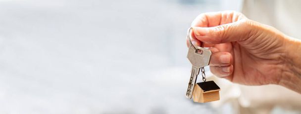 Woman holding  house key in hand.Mortgage loan approval home loan and insurance concept. - Foto, Imagen