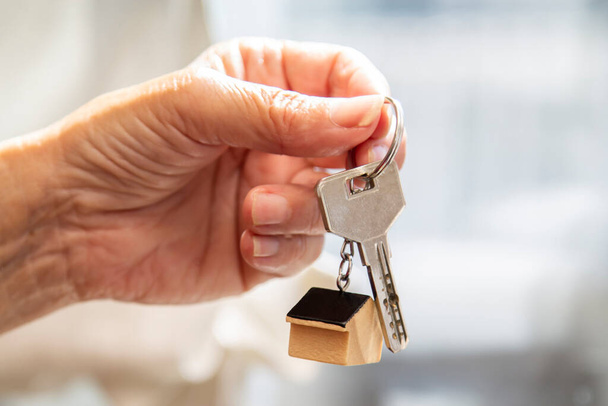 hand holding keychain with house or apartment keys - Zdjęcie, obraz