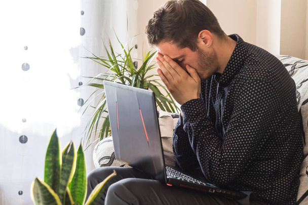 stressed and worried man with his laptop at home or in the office - Foto, Bild