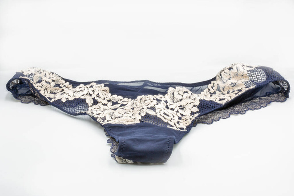 Blue lace panties closeup on white. Lingerie, female lace lingerie, womans erotic panties. - Photo, Image