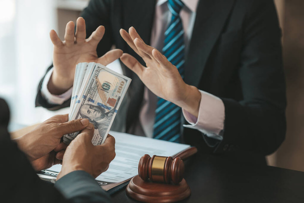 Individuals are giving bribes to officials in order to commit corruption in lawsuits, illegal actions by law enforcement by paying bribes to officials are illegal and unlawful. Fraud concept. - Фото, зображення