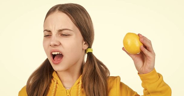 citrus fruits. natural organic fresh lemon. healthy life. kid facial expression. happy teen girl with lemon citrus fruit. vitamin and dieting. child eating healthy food. childhood health. - 写真・画像