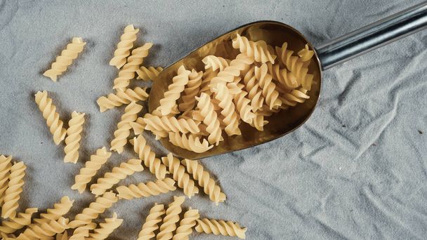 pasta in a dish dry appetizing spiral macaroni in the kitchen food preparation - Foto, Bild