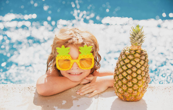 Children swimming and playing in water, happiness and summertime. Kid summer. Summer pineapple fruit. Funny amazed face - Photo, image