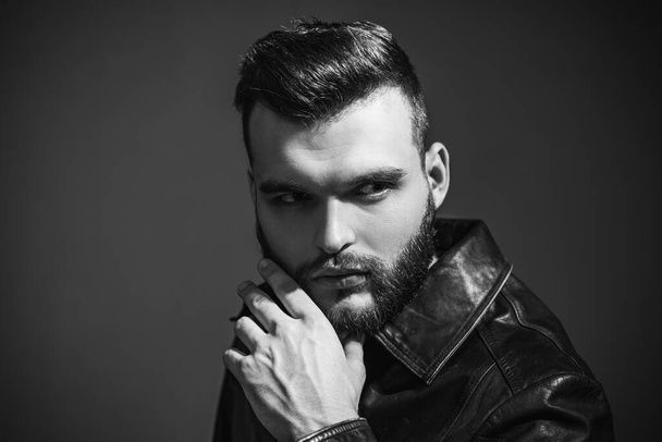 Handsome confident man. Serious guy posing in studio. Stylish haircut, hairstyle. Hair style - Fotografie, Obrázek