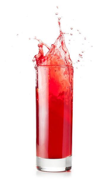 Red liquid is spalsing in glass - Photo, image