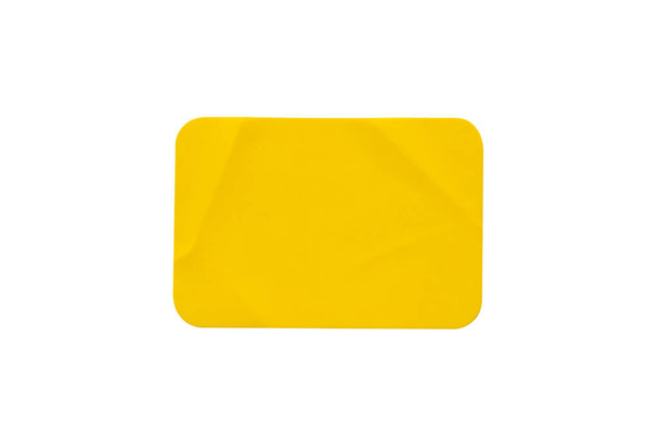 Yellow plastic sticker label isolated on white background - Foto, imagen