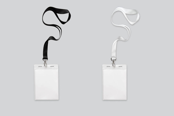 Two ID card holder with black and white colored lanyard mockup isolated on white background. 3d rendering. - Photo, Image