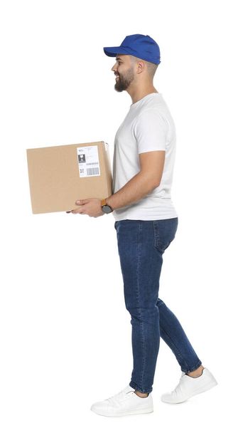 Happy young courier with cardboard box on white background - Photo, Image