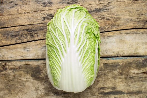 Fresh chinese cabbage on wooden background - Фото, изображение