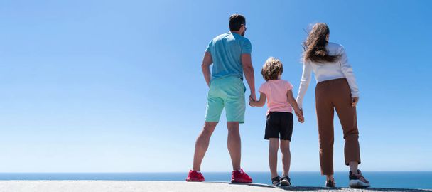 Family summer banner with mother and daughter, father and son. Mom dad and child love relax together. Banner of family embracing on sea beach. Summer family vacation, horizontal banner - Foto, Imagen