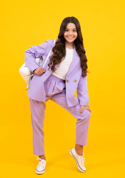 School teen girl in with backpack. Teenager student on yellow isolated background. Learning, education and knowledge. Happy teenager, positive and smiling emotions of schoolgirl - Foto, imagen