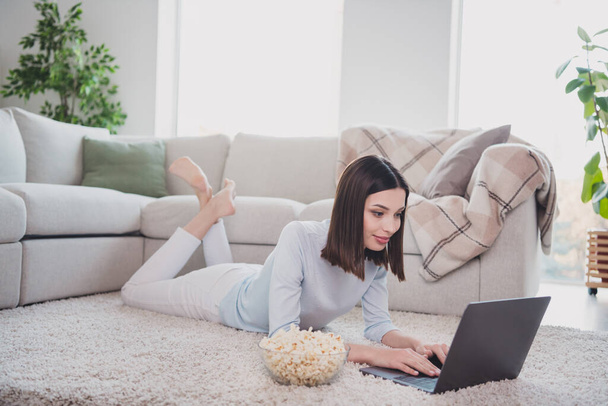Full body photo of positive lady laying carpet floor use wireless netbook social network free time house indoors. - Fotoğraf, Görsel