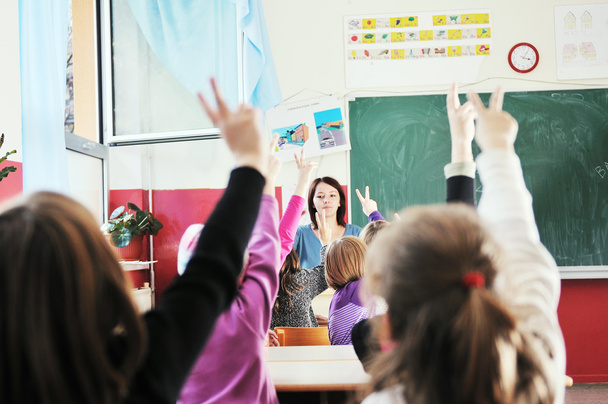Happy kids with teacher in school classroom - Zdjęcie, obraz