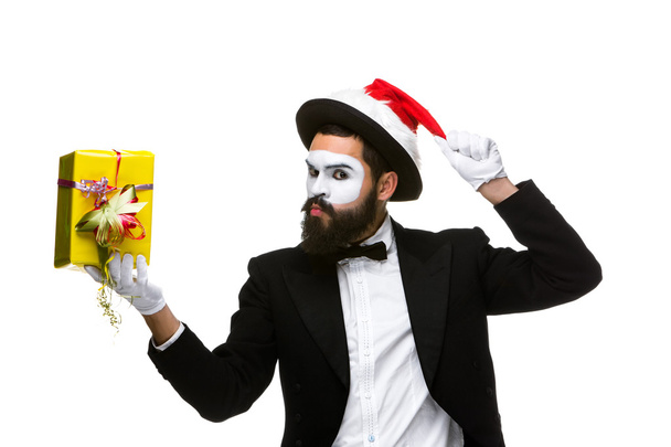 Man with christmas hat and a gift in their hands - Fotoğraf, Görsel
