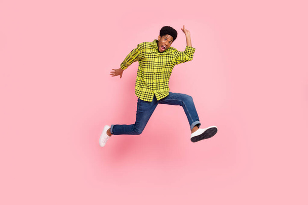 Full size photo of young funky brunette guy jump wear shirt jeans sneakers isolated on pink background. - Fotografie, Obrázek