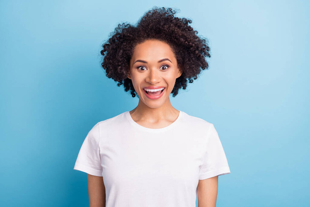 Portrait of attractive brunette amazed cheerful girl good news isolated over bright blue color background. - Foto, imagen