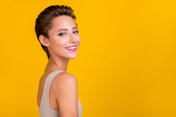 Profile side view portrait of attractive cheerful girl posing copy space ad isolated over bright yellow color background. - Fotoğraf, Görsel