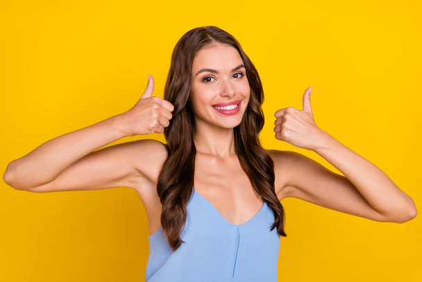 Photo of young woman happy positive smile show thumbs-up feedback advert recommend isolated over yellow color background. - Foto, immagini