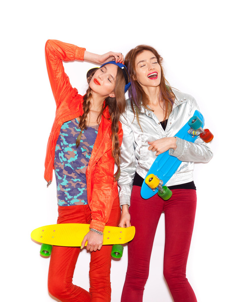 Two young girl friends standing having fun together - Фото, изображение