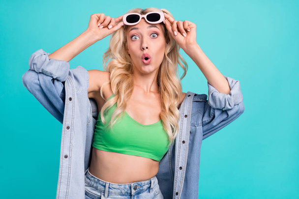 Photo of amazed shocked positive woman wear sunglss astonished sale news isolated on blue color background. - Foto, imagen