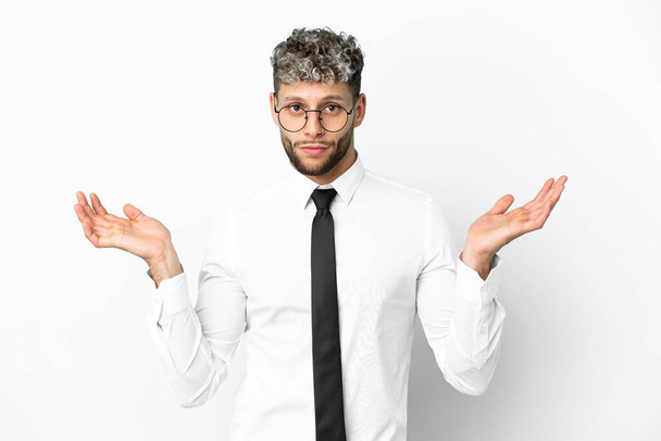 Business caucasian man isolated on white background having doubts while raising hands - Φωτογραφία, εικόνα