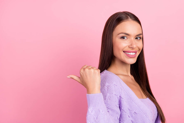 Photo of cheerful happy young woman point finger empty space thumb news isolated on pink color background. - Фото, зображення
