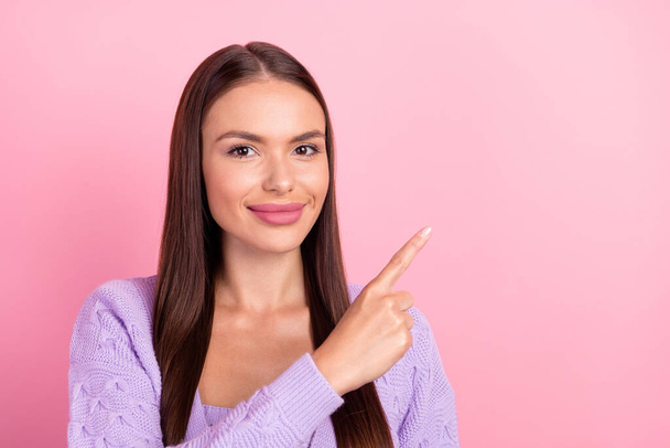 Photo of promoter positive lady indicate finger empty space wear purple cardigan isolated pink color background. - Φωτογραφία, εικόνα