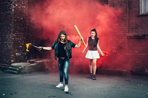 Two Bad girls with Molotov cocktail and red smoke bomb - 写真・画像