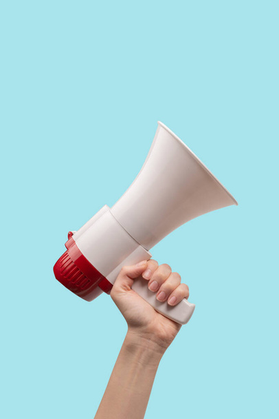 Megaphone in woman hands on a white background.  Copy space.  - Valokuva, kuva