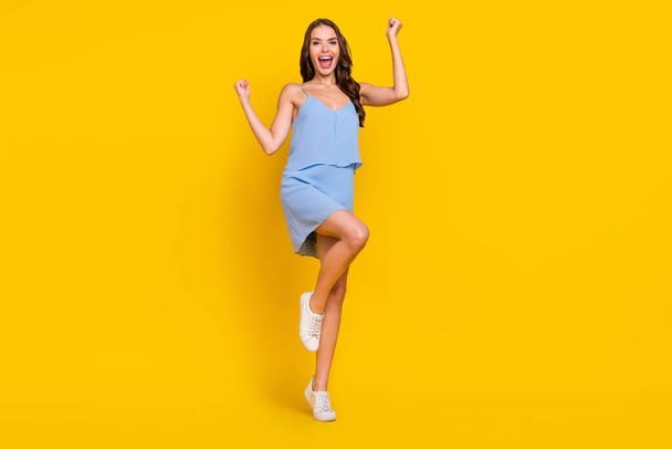 Full length photo of young excited woman happy positive smile rejoice victory success isolated over yellow color background. - Fotó, kép